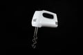 Modern mixer or hand mixer for kitchen cooking isolated on dark background. Electric tool for mixing food or liquids