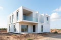 Modern modular home construction site with white prefabricated structure under clear sky Royalty Free Stock Photo