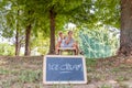 Modern mom and young daughter eating ice cream sitting on a deckchair in a water park on summer Royalty Free Stock Photo