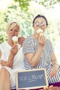 Modern mom and young daughter eating ice cream Royalty Free Stock Photo