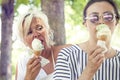 Modern mom and young daughter eating ice cream Royalty Free Stock Photo