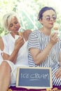 Modern mom and young daughter eating ice cream Royalty Free Stock Photo