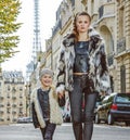 Modern mother and daughter in Paris, France going forward