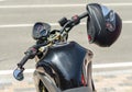 Modern motorcycle cafe racer and black helmet on a city street close up Royalty Free Stock Photo