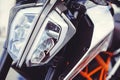 Modern motorcycle headlight, close-up on the front Royalty Free Stock Photo