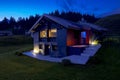 Modern mountain chalet in the middle of the evening as the sun sets and the night rises. Beautiful and evocative colours. Romance