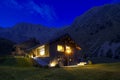 Modern mountain chalet in the middle of the evening as the sun sets and the night rises. Beautiful and evocative colours. Romance