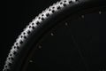 Modern MTB race mountain bike tyre isolated on black background