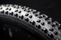 Modern MTB race mountain bike tyre isolated on black background