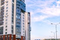 Modern multi-storey building with a glass facade. The evening sunset sky is reflected in the Windows of the facade Royalty Free Stock Photo