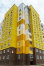 Modern multi-storey house in a new residential complex against the blue sky. The concept of mortgage housing lending and a happy Royalty Free Stock Photo