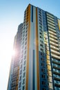 Modern multi-storey residential building against blue sky. New multicolored high-rise house. View from below Royalty Free Stock Photo