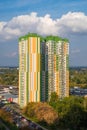 Modern multi-storey residential complex `Fundament` against the backdrop of a cloudy blue sky.