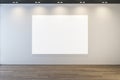 Modern museum or exhibition hall interior with clean illuminated white mock up banner on concrete wall and wooden parquet flooring Royalty Free Stock Photo