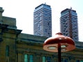 Modern mushroom shaped LED street lamp detail with condo towers in the background Royalty Free Stock Photo