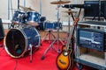 Modern music instruments and equipments for rock band in empty rehearsal room Royalty Free Stock Photo