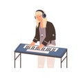 Modern musician standing in headphones and playing synthesizer. Talented piano player performing melody on keyboard Royalty Free Stock Photo