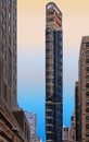 Modern narrow building skyscraper and architecture with blue sky in manhattan in new york Royalty Free Stock Photo