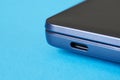Modern narrow steel ultrabook laptop on a blue background. USB type-c port. Close-up. Macro
