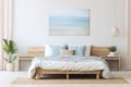 Modern nautical bedroom interior. Wooden double bed with pillows. Abstract light blue wall art on a white wall