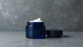 Modern navy blue shaving cream jar on concrete backdrop