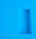 Modern neon blue colored brick wall texture background with empty framework opening Royalty Free Stock Photo