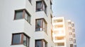 Exterior of a modern multi-story apartment building - facade, windows and balconies. Royalty Free Stock Photo