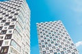 Modern and new apartment building. Photo of a tall block of flats against a blue sky. Royalty Free Stock Photo