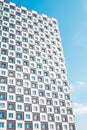 Modern and new apartment building. Photo of a tall block of flats against a blue sky. Royalty Free Stock Photo