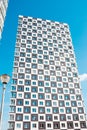 Modern and new apartment building. Photo of a tall block of flats against a blue sky. Royalty Free Stock Photo