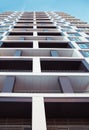 Modern and new apartment building. Photo of a tall block of flats against a blue sky. Royalty Free Stock Photo