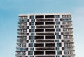 Modern and new apartment building. Photo of a tall block of flats against a blue sky. Royalty Free Stock Photo