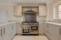 Modern new generic fitted kitchen with range style oven and hood