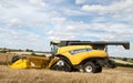 Modern New Holland combine harvester cutting crops Royalty Free Stock Photo