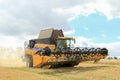 Modern New Holland combine harvester cutting crops