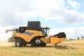 Modern New Holland combine harvester cutting crops