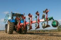 Modern new holland tractor pulling a plough Royalty Free Stock Photo