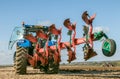 Modern new holland tractor pulling a plough Royalty Free Stock Photo