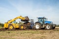 Modern New Holland tractor Tractor being loaded up with muck for muck spreading Royalty Free Stock Photo