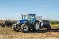 Modern New Holland tractor Tractor spreading manure on fields Royalty Free Stock Photo