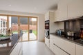 Modern new kitchen with bifold doors to garden and patio