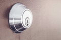 Modern new metallic grey shiny keyhole on door background. Side view of keyway Royalty Free Stock Photo