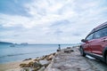 Modern new red SUV car on the road with Summer sea background of free space for summer text and travel transportation background Royalty Free Stock Photo