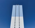 Modern new residential concrete high-rises on a background of the sky. Front view part of multi-storey new built.