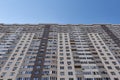 Modern new residential concrete high-rises on a background of the sky. Front view part of multi-storey new built.