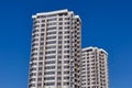 Modern new residential concrete high-rises on a background of the sky. Front view part of multi-storey new built.