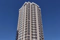 Modern new residential concrete high-rises on a background of the sky. Front view part of multi-storey new built.