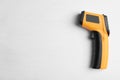 Modern non-contact infrared thermometer on wooden background, top view. Space for text Royalty Free Stock Photo