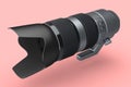 Modern nonexistent silver DSLR telephoto camera lens on pink background