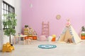 Modern nursery room interior with play tent